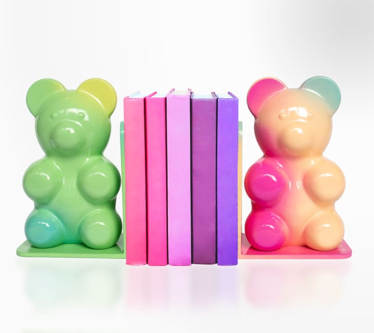 Colorful gummy bear bookends with pink and purple books in between.