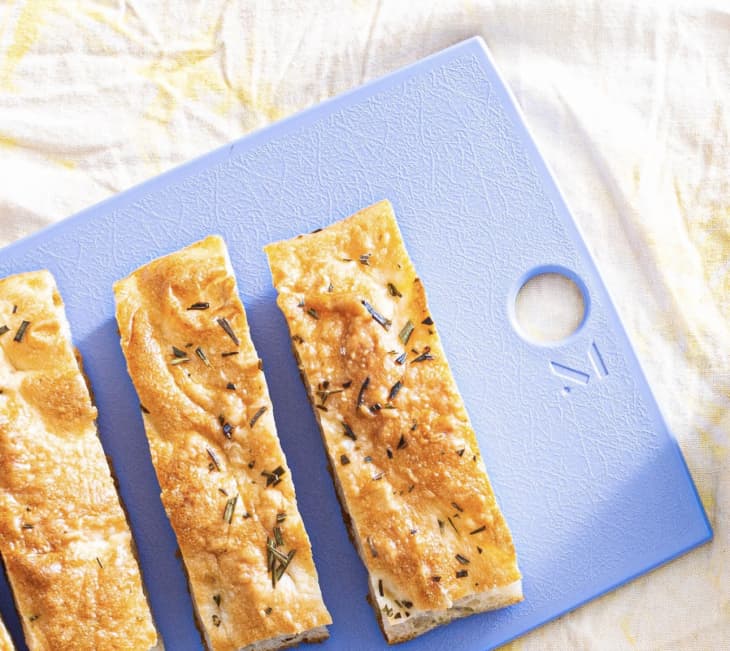 blue cutting board holding bread