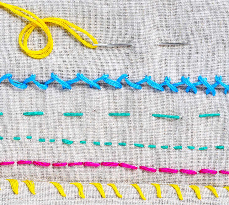 4 different stitching lines of blue, green, pink, and yellow in canvas-like material.