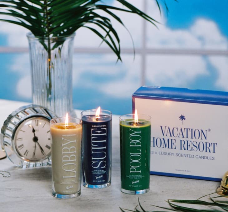 Three lit candles labeled Lobby, Suite, and Pool Boy next to a clock and Vacation Home Resort box.