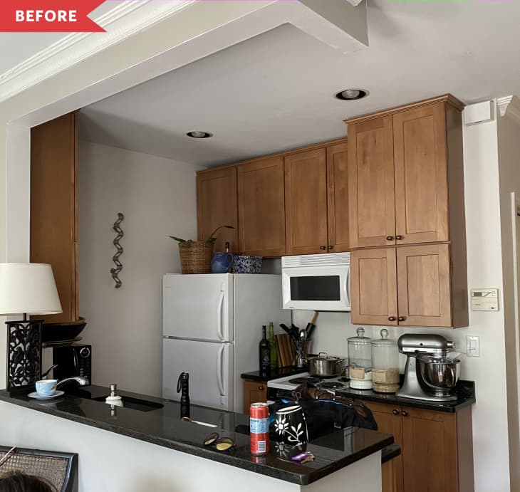 Before: kitchen with brown cabinets and black counters