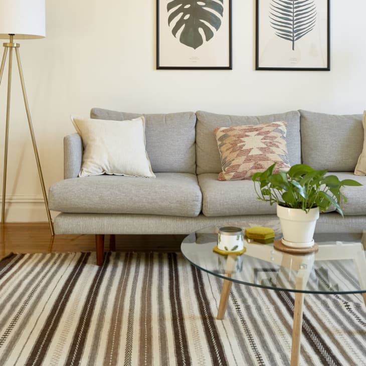 a light gray couch in a beige-walled room