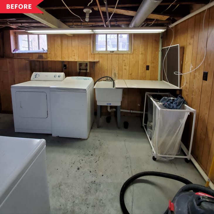 Before: Dark laundry room with concrete floors and paneled wood walls