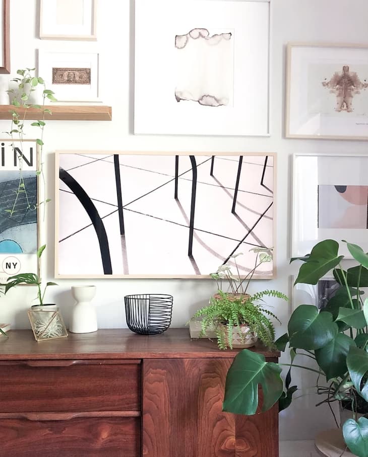 A TV disguised as an abstract art print in a gallery wall