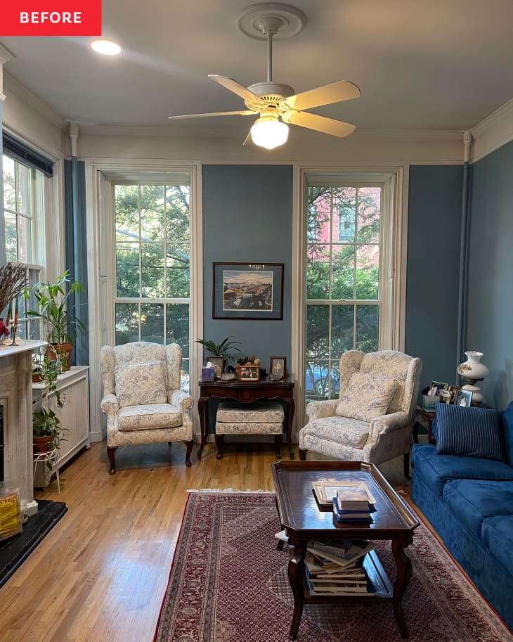 Parlor floor living and dining area before home staging with blue walls, lots of patterned furniture, blue velvet sofa, wood floor