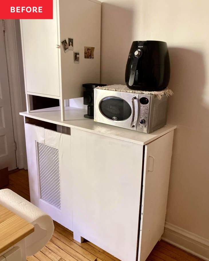 DIY kitchen cabinet that covers a radiator and has a microwave and air fryer on top of it