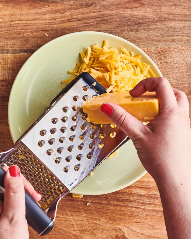 Someone grating cheese.
