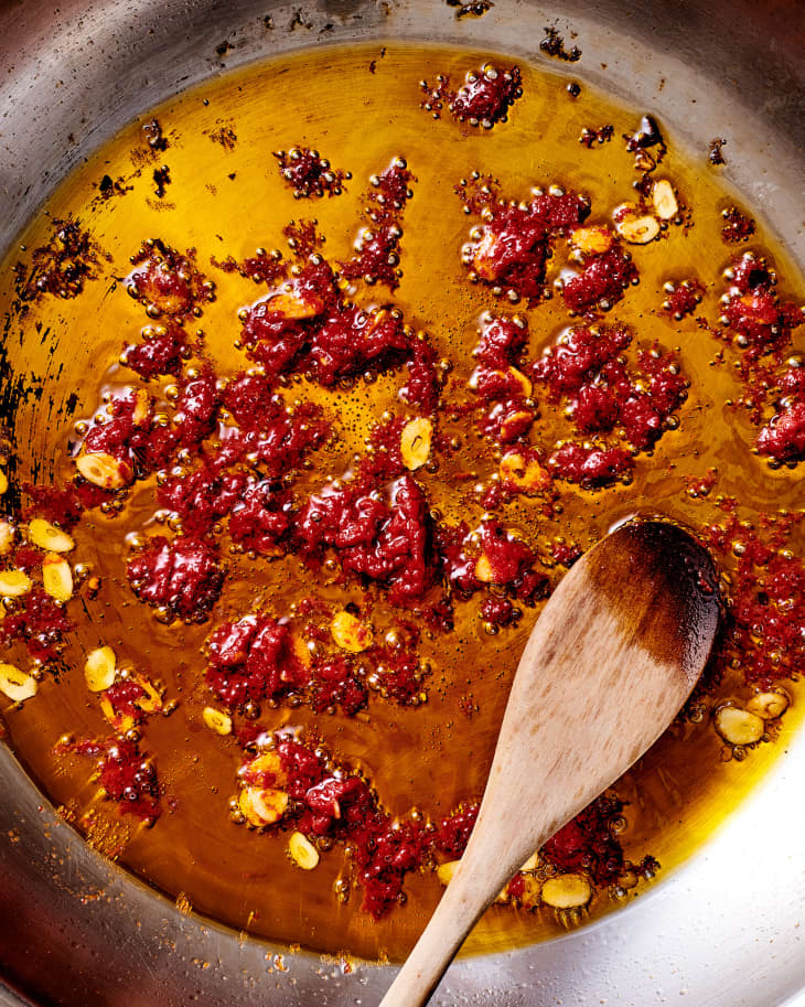 Caramelized tomato paste in skillet.