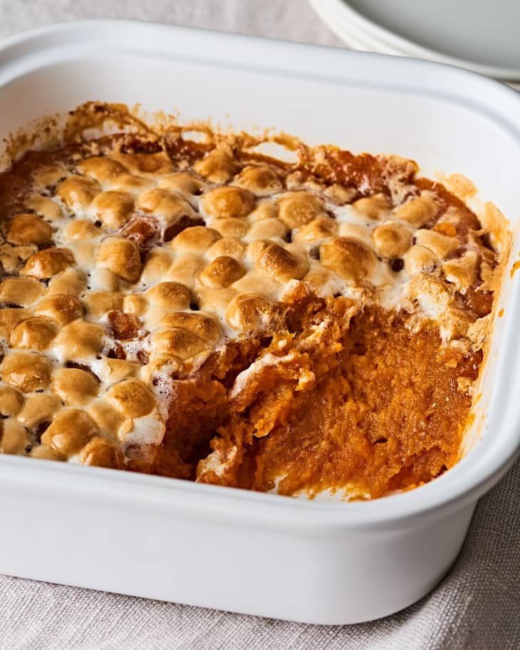 Sweet potato casserole topped with toasted marshmallows in a white baking dish.