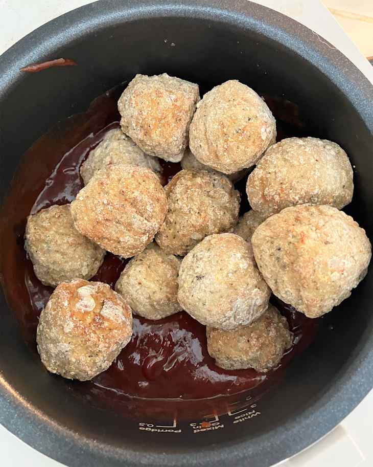 Meatballs in slow cooker with marinade.