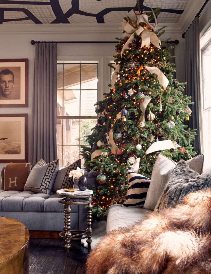 christmas tree decorated with white ribbon in living room