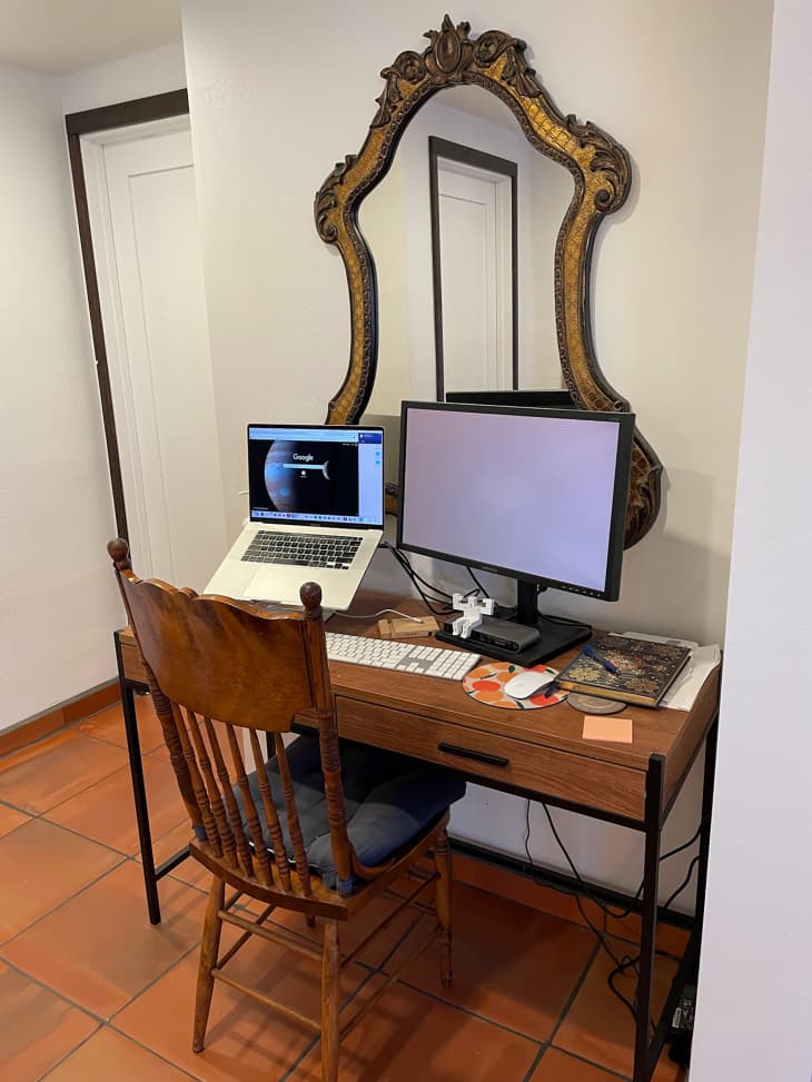 Home office with vintage mirror above desk and monitors.