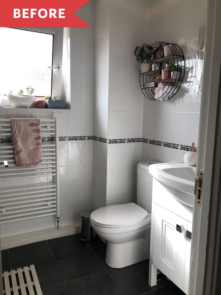 Small bathroom with white tiles, wall shelf with plants, towels, and decor, and a towel radiator under a window.
