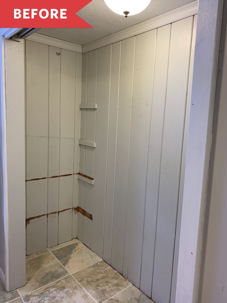 A boring empty gray closet with tile flooring