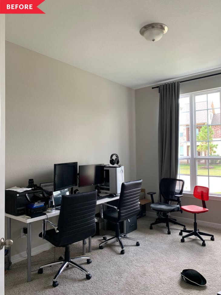 Home office with two desks, black chairs, computers, and a large window with gray curtains.