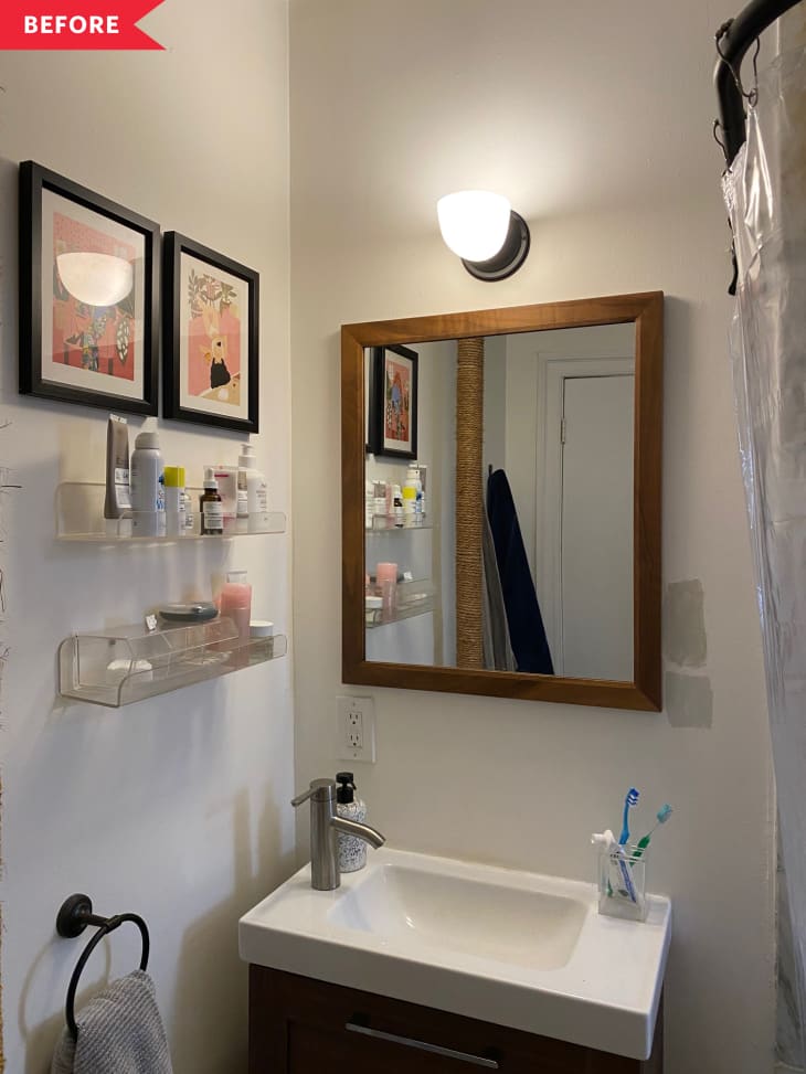 Before: White bathroom with black vanity and brown mirror
