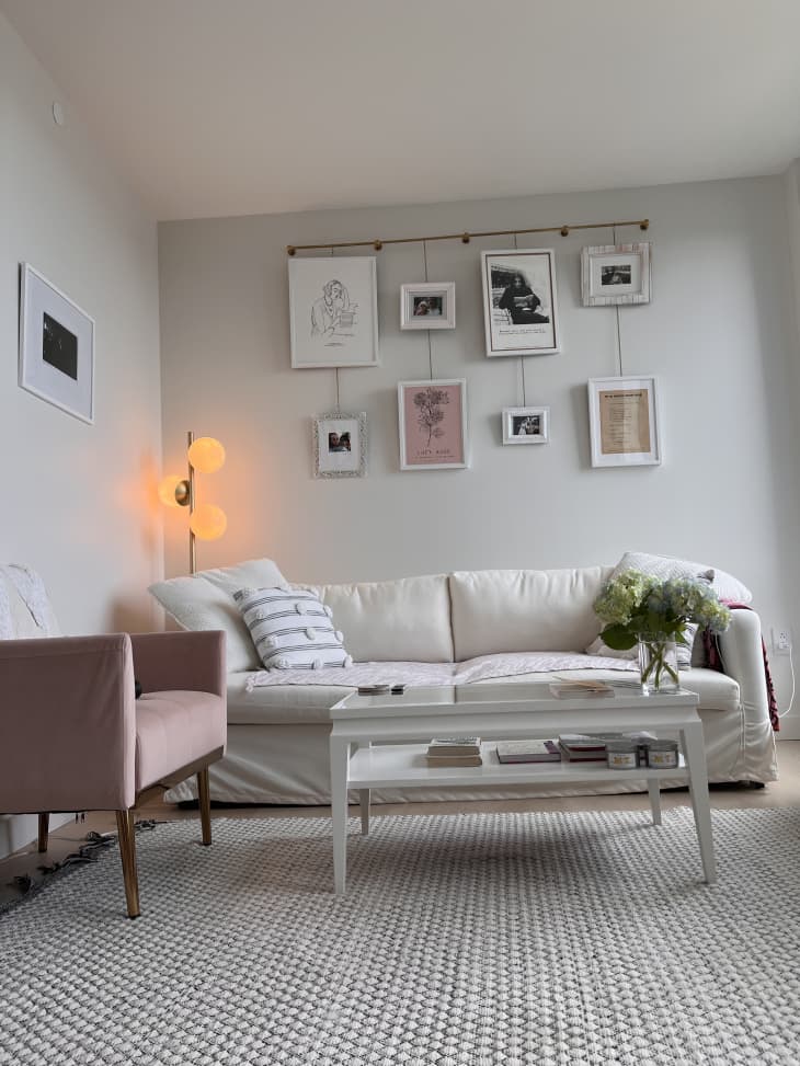 白色的客厅，白色的沙发和粉红色的椅子