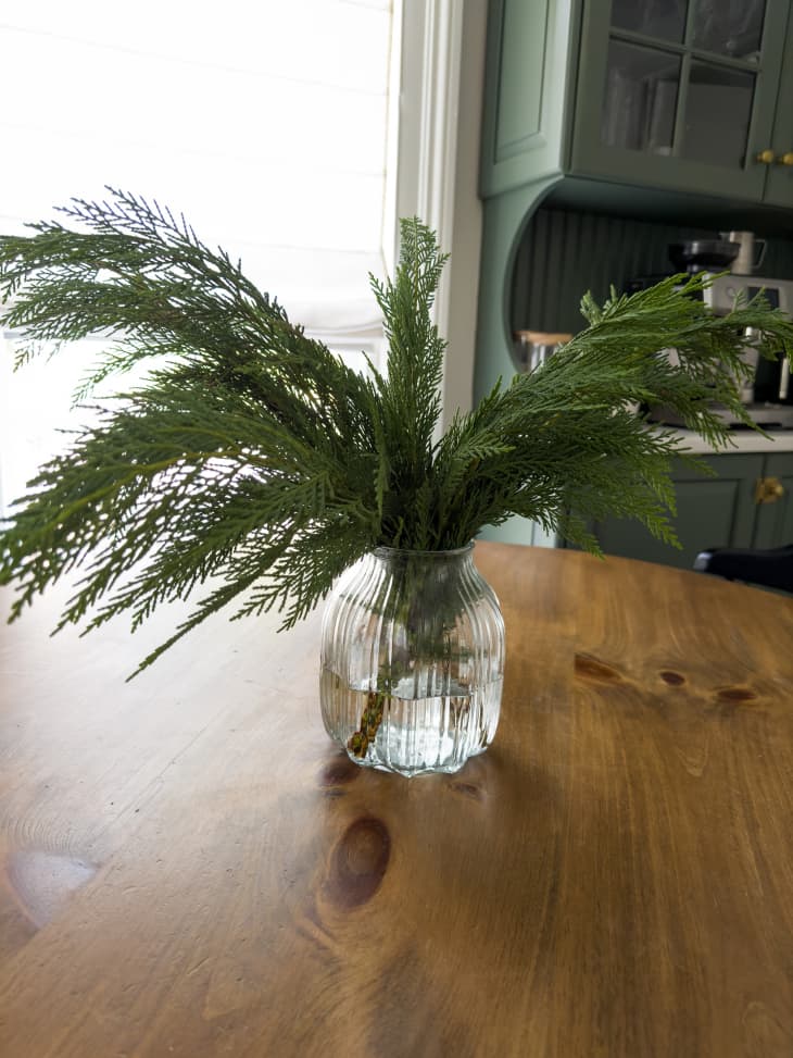 Evergreen arrangement on dining room table.