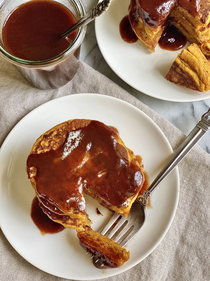 Photograph of pumpkin pancakes with syrup.