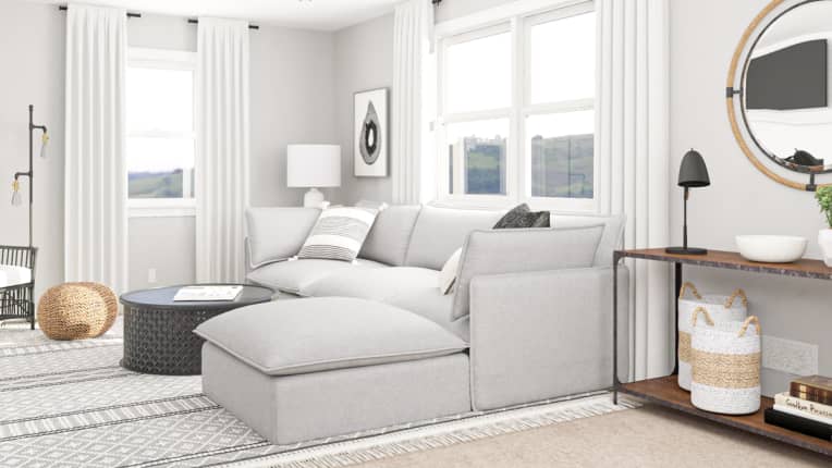 Living room where curtains are hung above windows and make ceilings look higher
