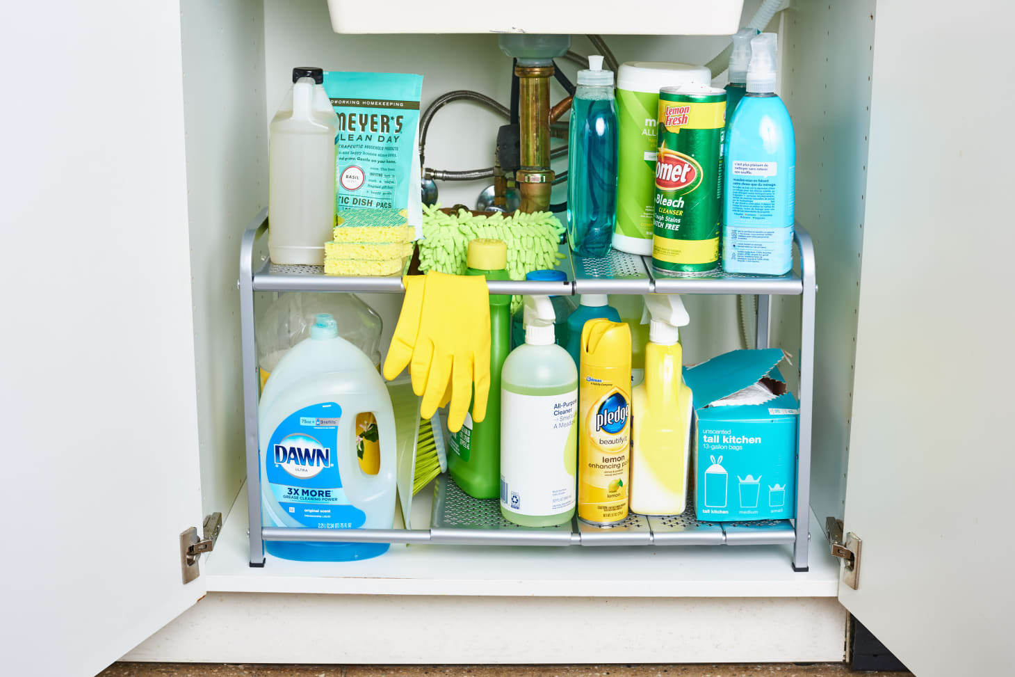  An organized shelf of cleaning supplies in a kitchen, including dish soap, gloves, and all-purpose cleaner.