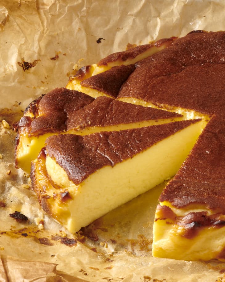 photo of a sliced basque cheesecake on parchment paper