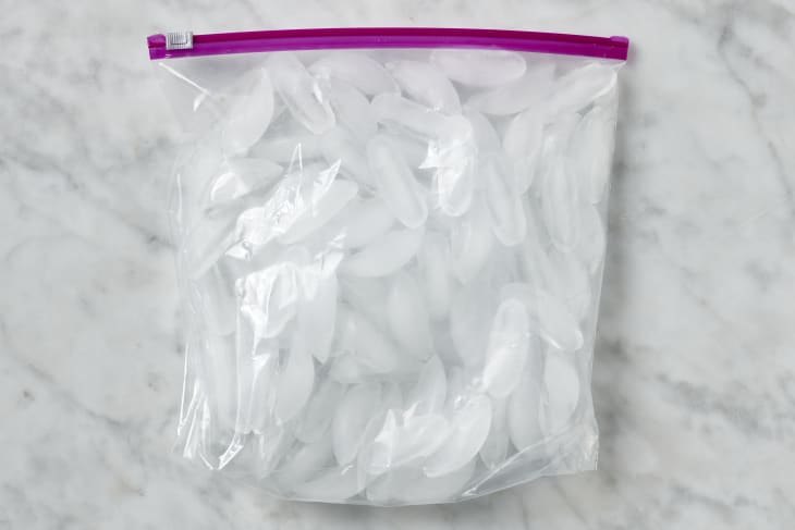 photo of a zip top bag full of ice on a marble counter