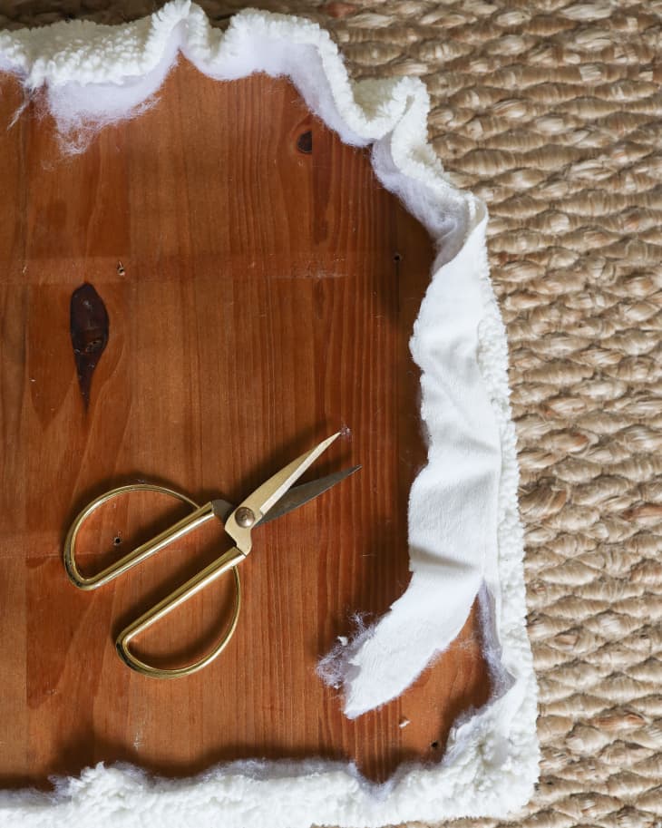 cloth wrapped around a wooden plank with scissors