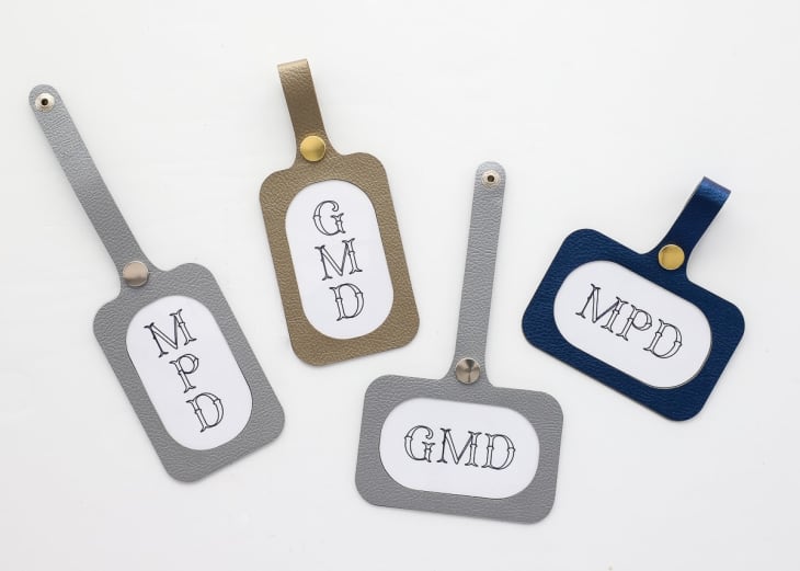 Four DIY faux leather luggage tags in silver, gold, and blu