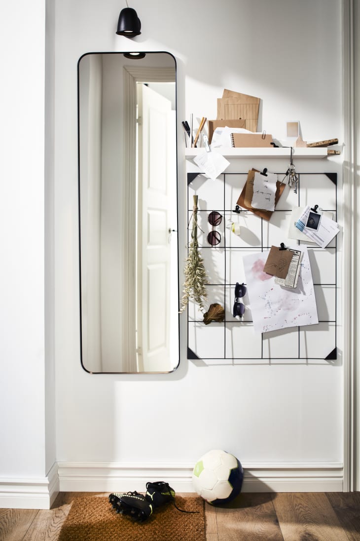 Wall with mirror, shelf and notes on display