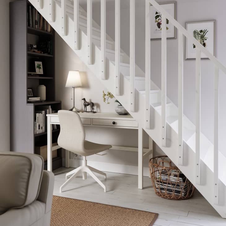 White IKEA desk and desk chair under stairs