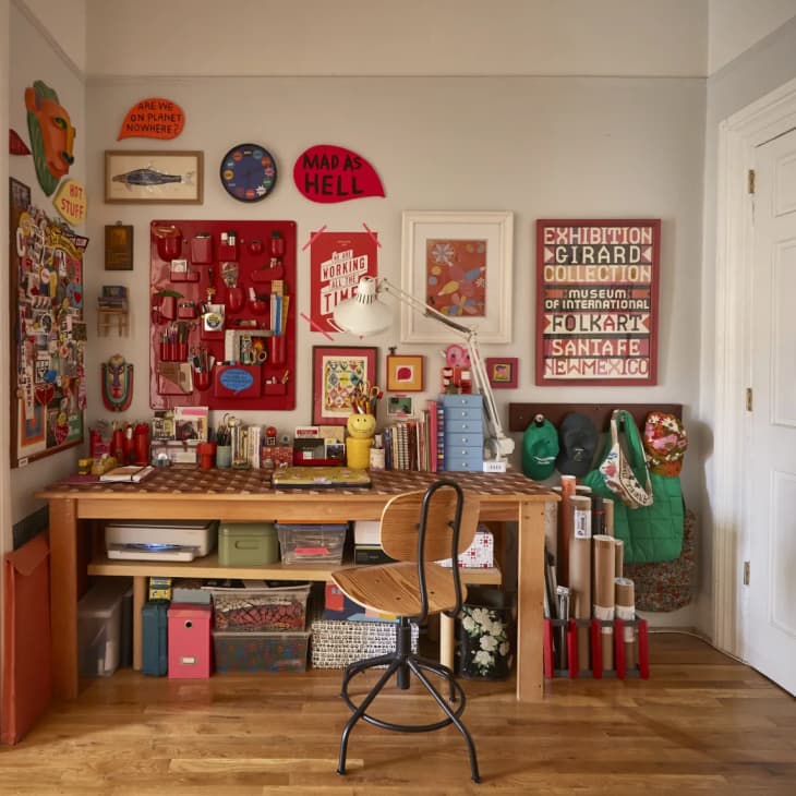 a large desk with a bench placed underneath for storage