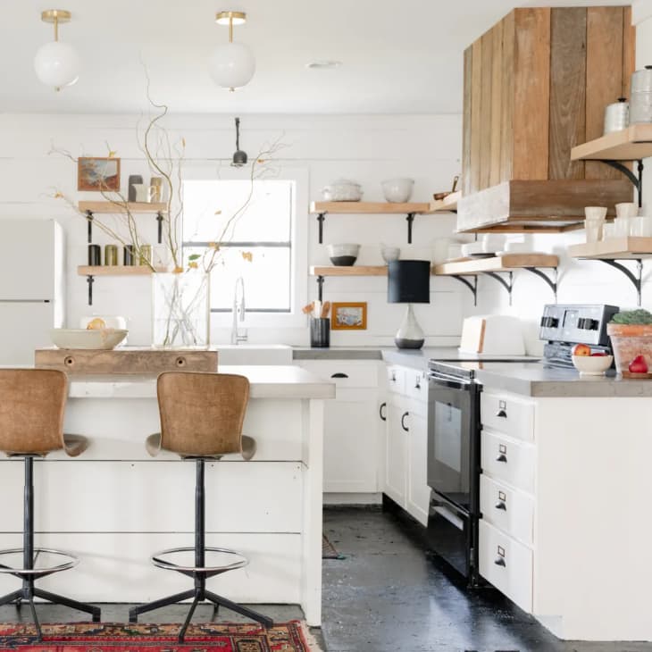a white industrial kitchen with reclaimed wood cabinetry