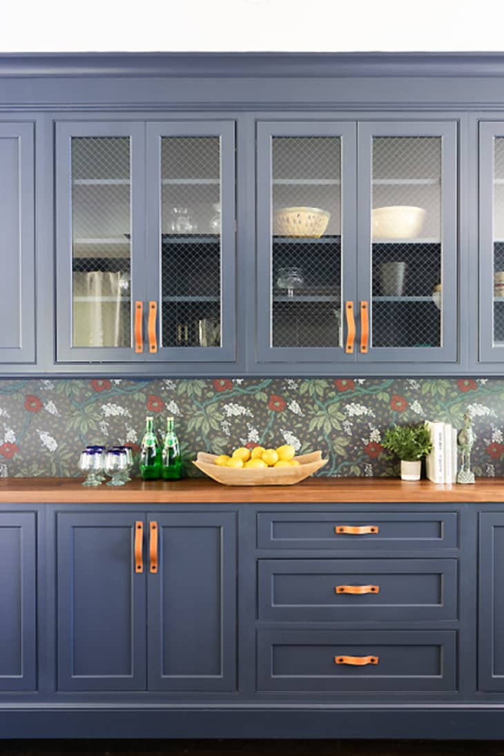 Dark blue cabinets with copper handles.