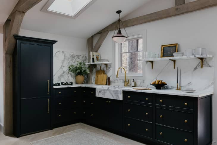 Bright kitchen with dark wood cabinets and refrigerator.