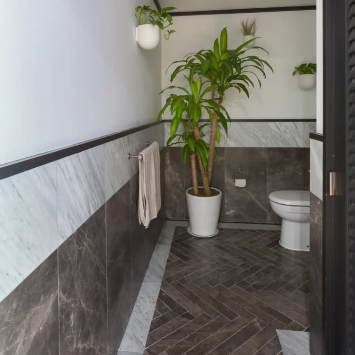 a large bathroom with light gray and dark gray tile