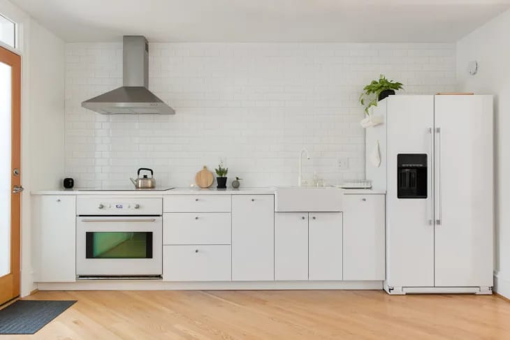 a minimalist white kitchen with IKEA cabinets