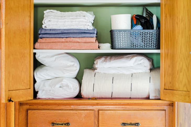 linen closet with towels, blankets, duvets, ironing gear. drawers down below