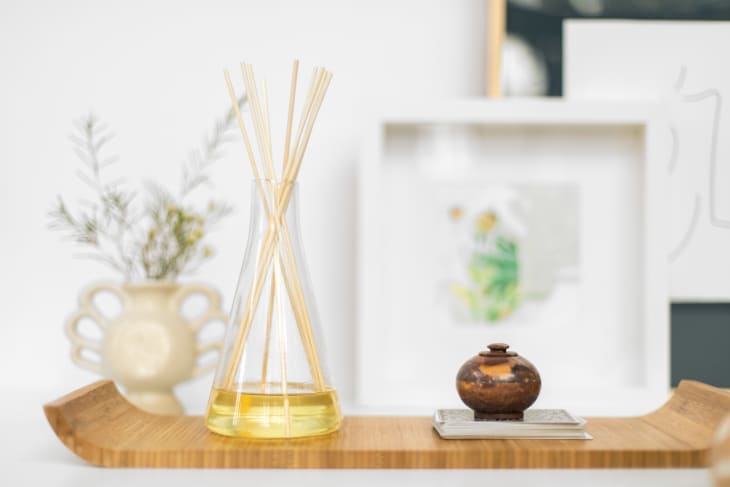 Reed diffuser on a wooden tray