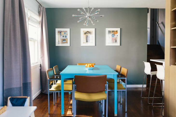 gray kitchen with turquoise table and mustard yellow chairs