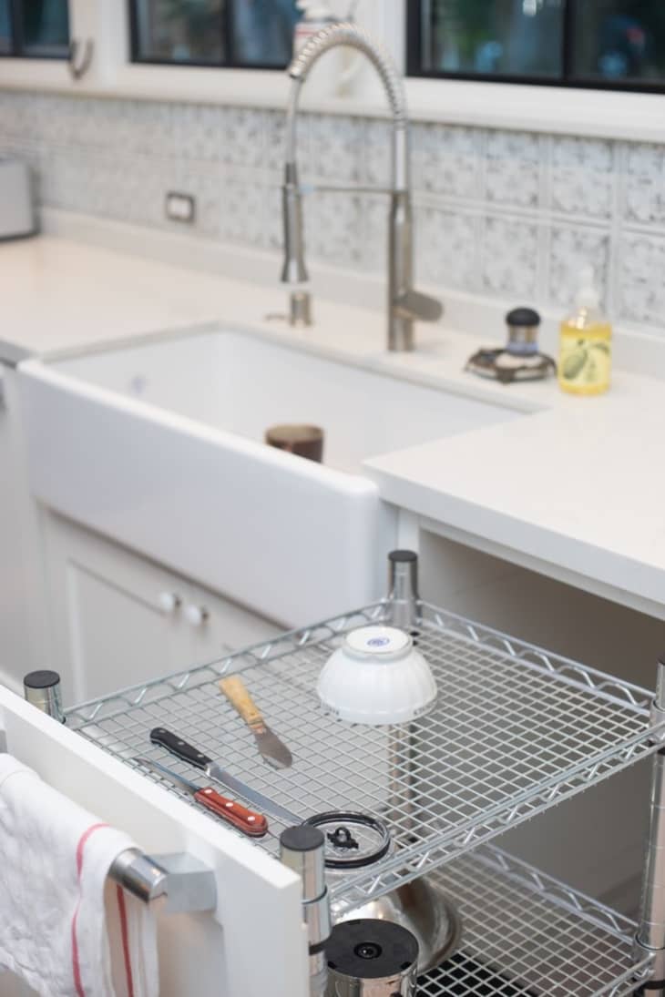 Custom, in-cabinet dish drying rack. Water drips directly into the