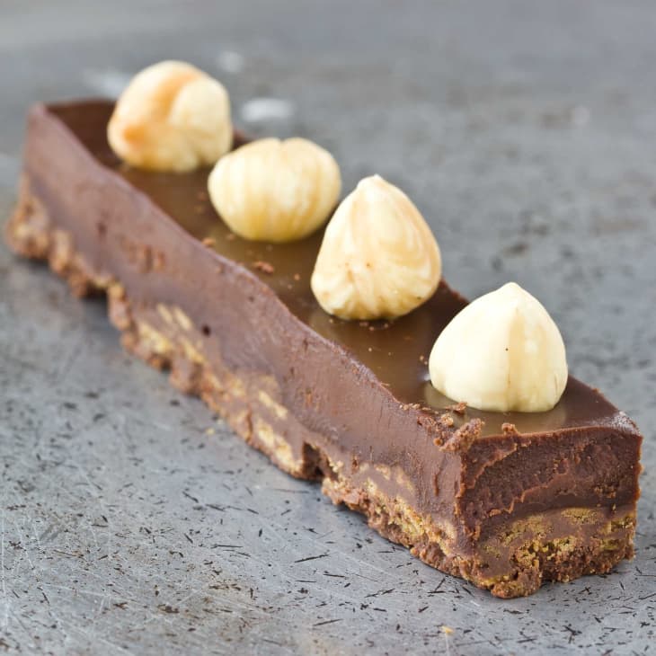 Chocolate-hazelnut crunch bar, with crunchy cookies in the base and four Macadamia nuts on top