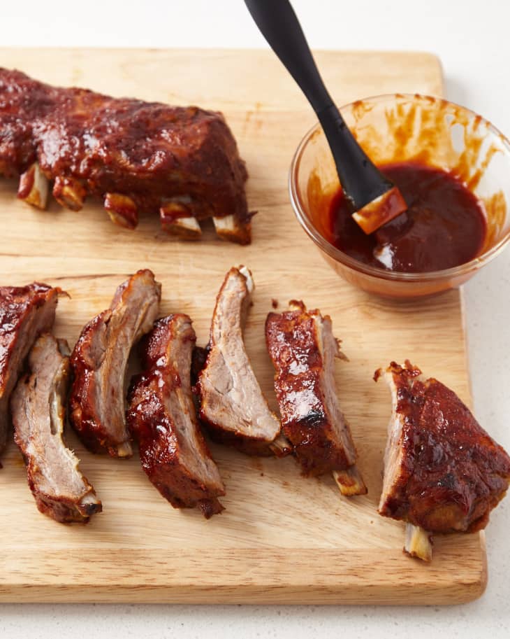 Baby back ribs that were cooked in a slow cooker, sliced with sauce
