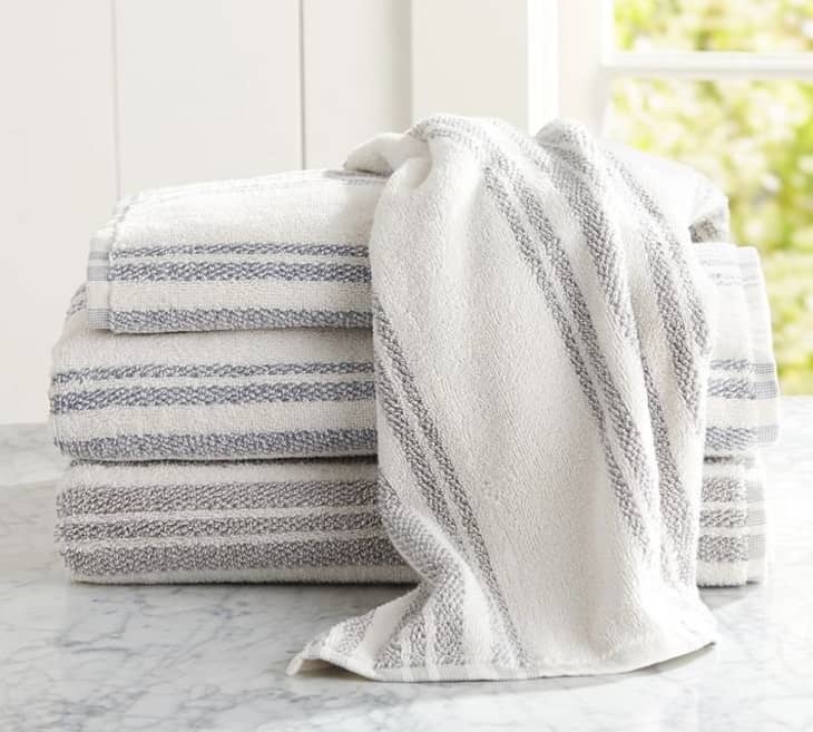 white folded towels near window