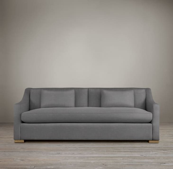 A gray couch against a gray wall.