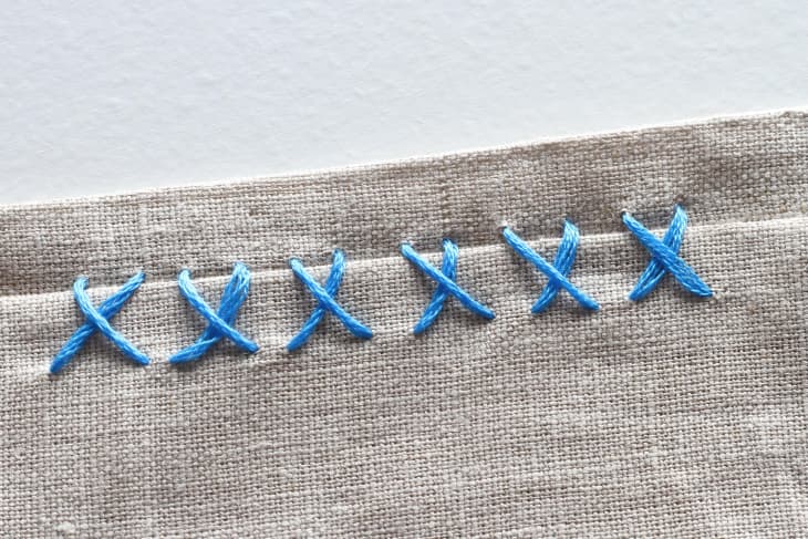 6 catchstitches with blue thread