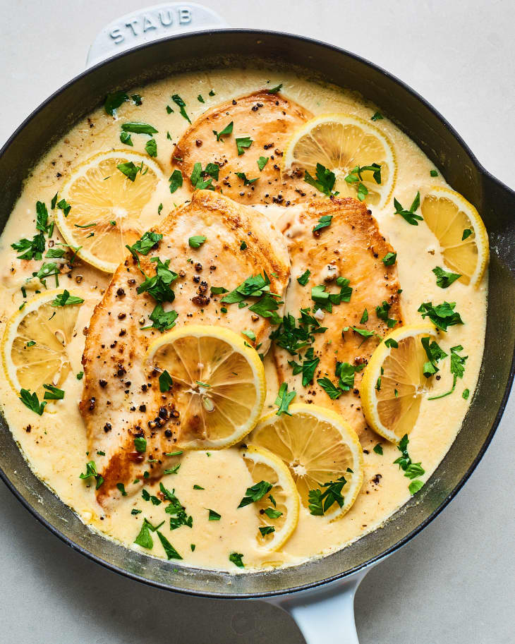 Chicken breast, cooked in creamy lemon garlic sauce, in a cast iron skillet