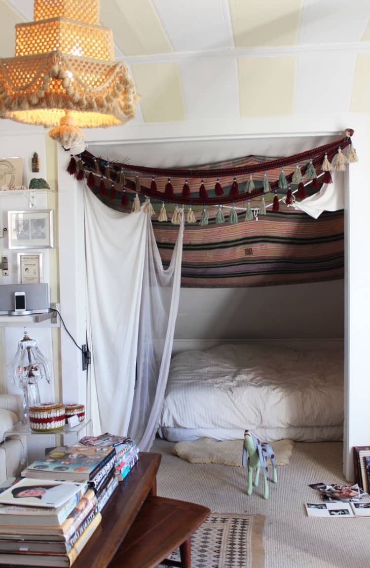 A Bohemian sleeping nook in California is decorated with tapestries and tassels
