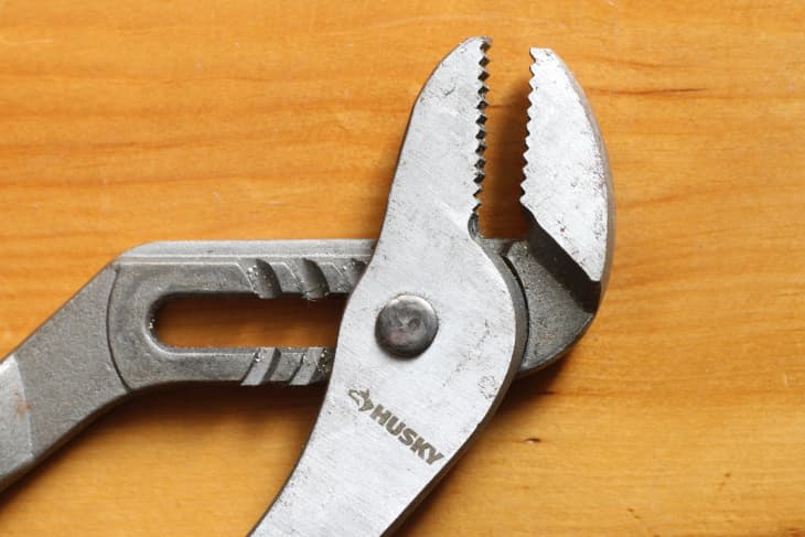 rusted adjustable pliers on a table