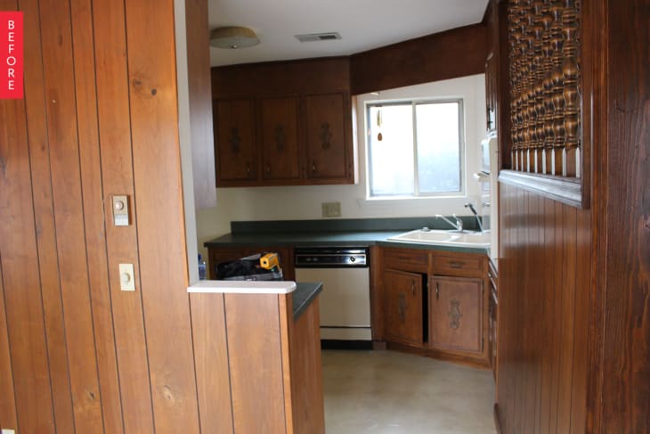 Before: a drab kitchen with wood paneling